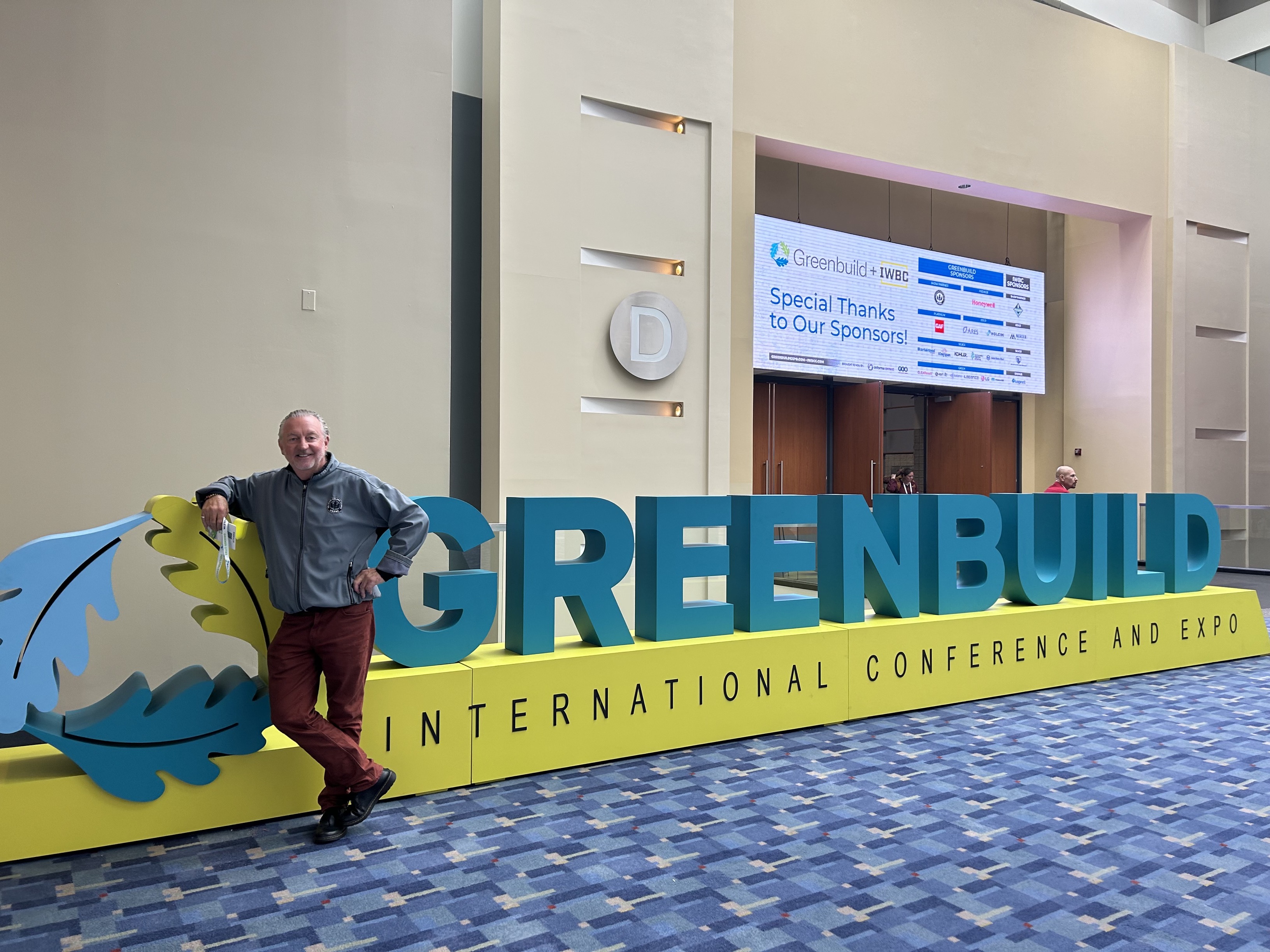 Introba founder Kevin Hydes standing by the Greenbuild conference sign